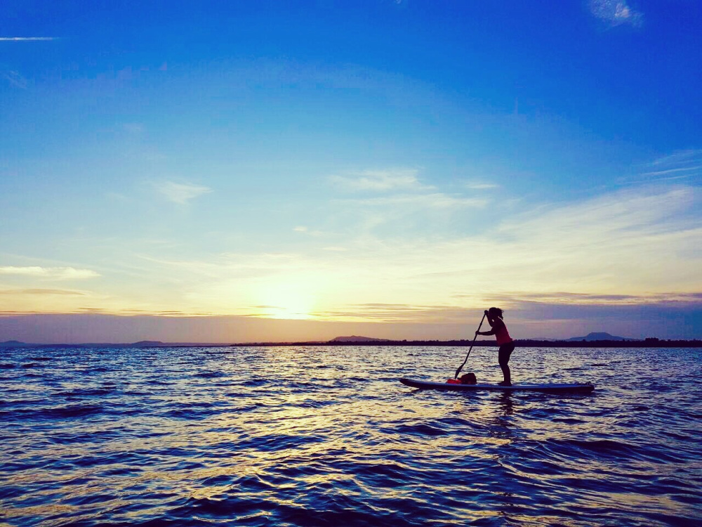 Stand-up paddling at dawn on Tri An lake